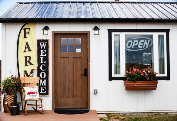 The Lucky Buffalo Farm Stand building, with its Farm and Welcome signs and the OPEN sign in the window